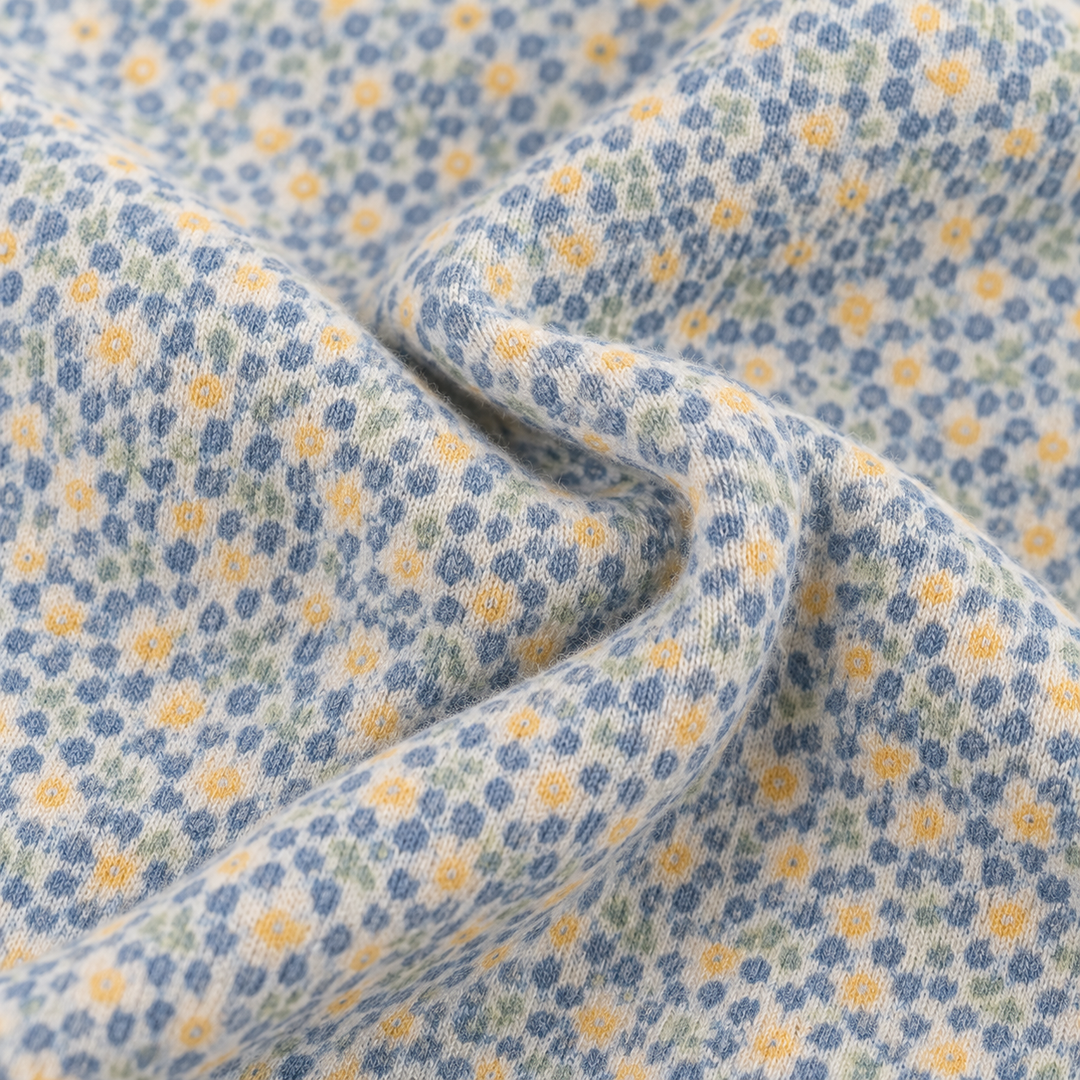 Close-up of soft fuzzy PAIGELAUREN Sage Polka Dot fabric