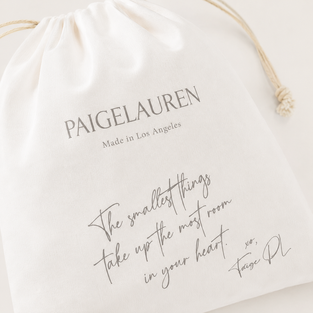 Close-up of PAIGELAUREN Signature Gift Bag with printed sentiment and drawstring detail