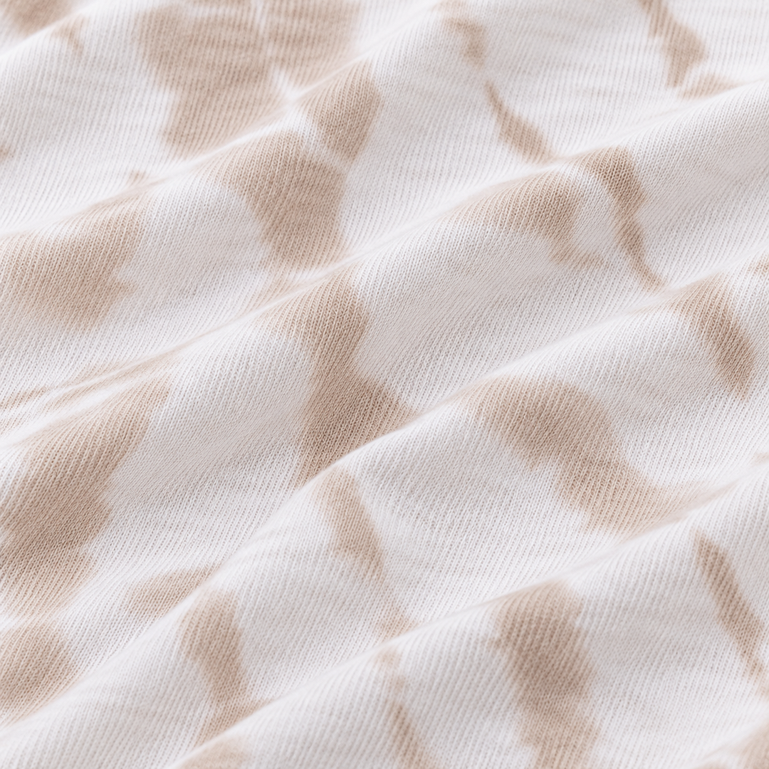 Close-up of PAIGELAUREN Beige tie dye baby rib fabric