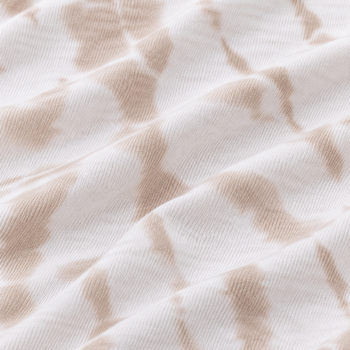 Close-up of PAIGELAUREN Beige tie dye baby rib fabric