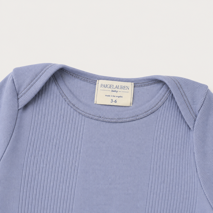 Lap shoulder neckline detail on PAIGELAUREN Variegated Rib Blue Footie Pajama