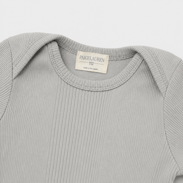 Lap shoulder neckline detail on PAIGELAUREN Variegated Rib Footie Pajama Gray
