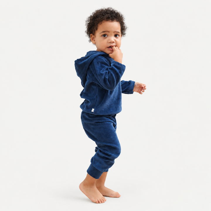 Toddler modeling the PAIGELAUREN Navy velour hoodie and jogger set