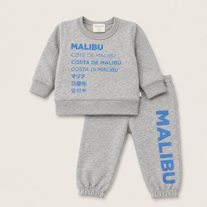 A two-piece kids' sweatshirt and jogger set in heather gray, featuring blue text graphics. The sweatshirt displays 'MALIBU' and alternative translations in blue across the chest, and the matching joggers feature 'MALIBU' printed vertically down the leg.