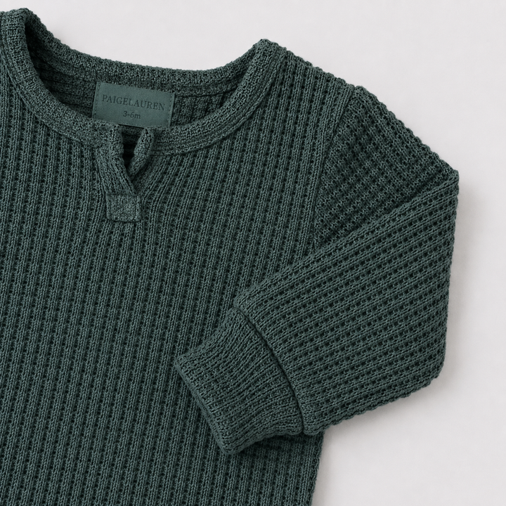 Dark Green matching sleeve cuff and chunky thermal texture on the PAIGELAUREN romper.