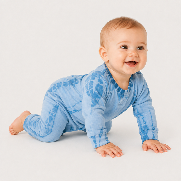 Crawling baby wearing the PAIGELAUREN blue tonal-dyed fleece romper.