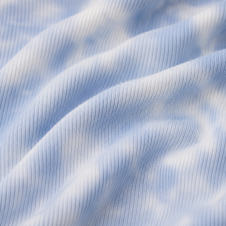 Close-up of the Light Blue Marble premium baby rib fabric used on the PAIGELAUREN Rib Marble Shortall Onesie