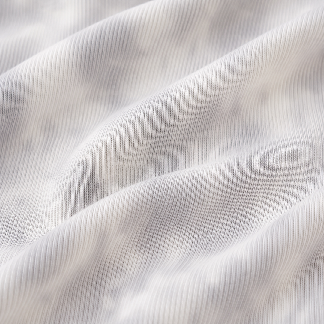 Close-up of the Light Gray Marble premium baby rib fabric used on the PAIGELAUREN Rib Marble Shortall Onesie