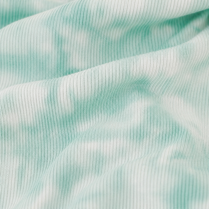 Close-up of the Light Green Marble premium baby rib fabric used on the PAIGELAUREN Rib Marble Shortall Onesie