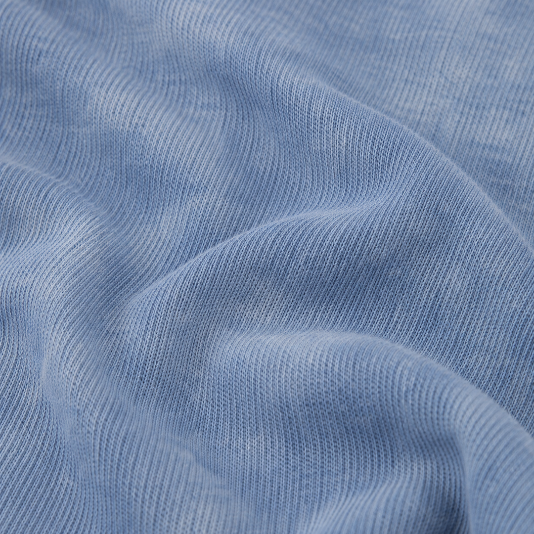 Close-up of premium blue marble dyed rib knit fabric on the PAIGELAUREN Rib Marble Henley Romper