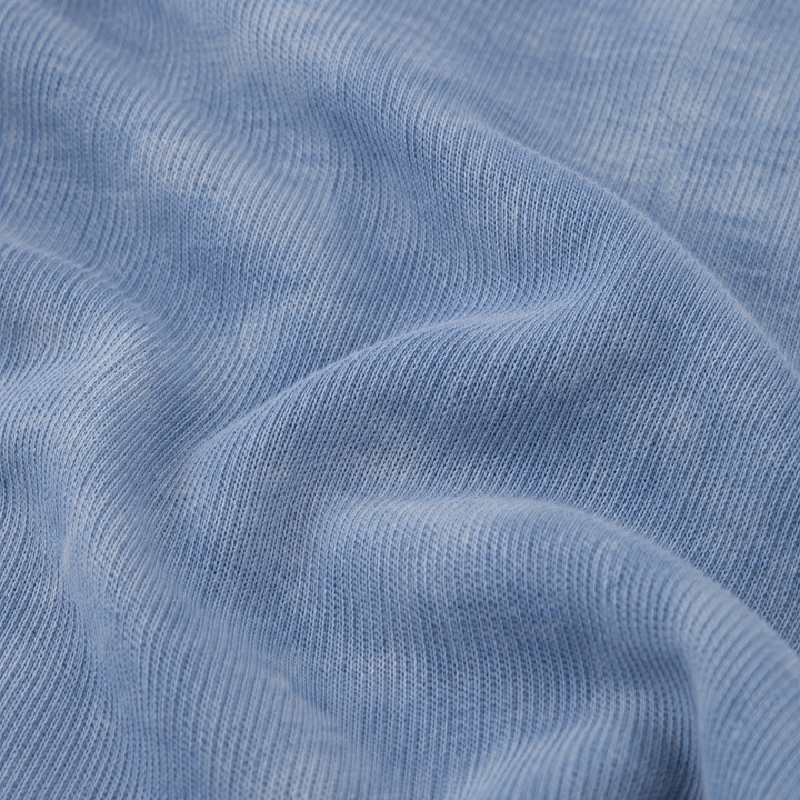 Close-up of premium blue marble dyed rib knit fabric on the PAIGELAUREN Rib Marble Henley Romper