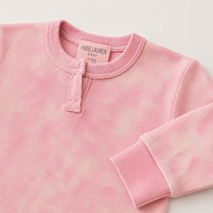 Close-up of the Henley placket and neckline on the PAIGELAUREN Rib Pink Marble Henley Romper